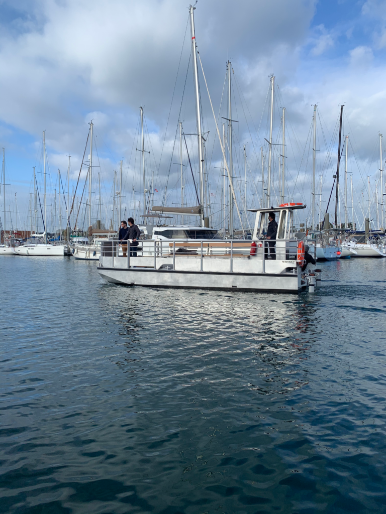 Bateau blanc sur l'eau au milieu d'un port.